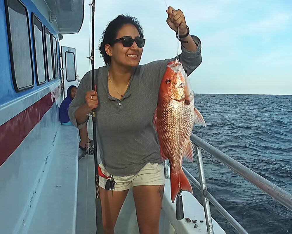 girl holding red snapper on destin fishing charter